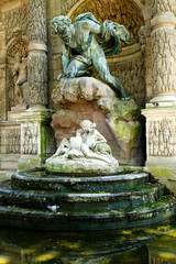 Fototapeta na wymiar Color DSLR stock image of the Medicis Fountain in Luxembourg Gardens, Paris, France, erected in 1861. The Left Bank, Latin Quarter landmark is popular with tourists and locals. Vertical. 