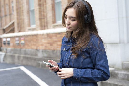 Young women are listening to music with headphones