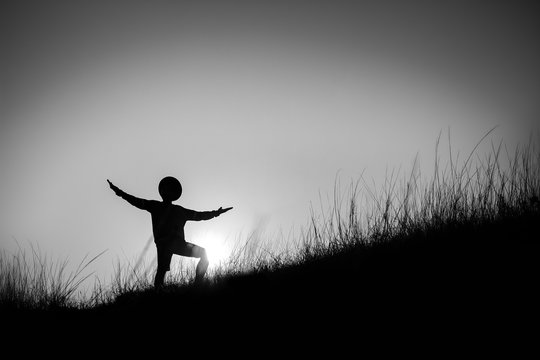 Fototapeta black and white  Silhouette of a man at the beautiful sunset on