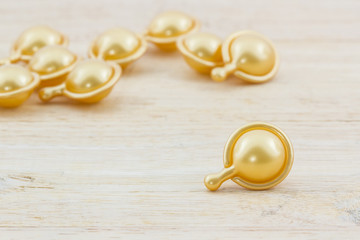 Hair vitamin serum capsule gold color.