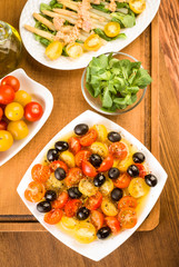 salad with cherry tomatoes and olives on wooden