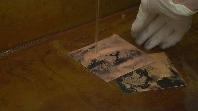 Man's Hands in Gloves Are Washing Two Copper Plates in Water under the Water Tap Engraved Pictures of a Girl's Face on a Copper Plates Workshop