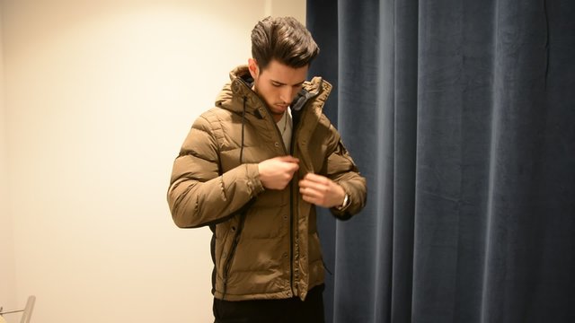 Young Man Trying on Clothes in Clothing Store