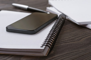 black smartphone in the workplace closeup