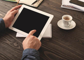 man presses on the screen white tablet