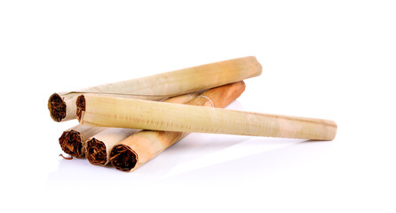 Tobacco pile and cigarette on white background