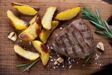 Top view of grilled filet mignon beefsteak with potato wedges