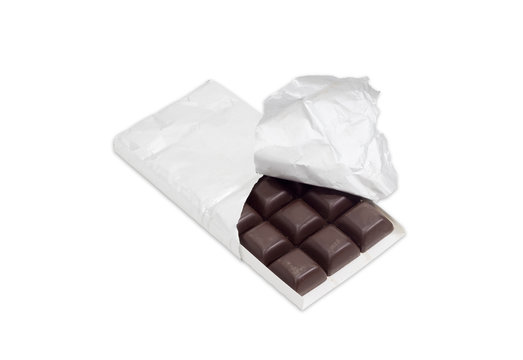Dark chocolate in the opened packing on a light background