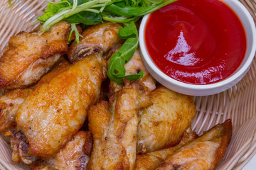 Fried chicken wings with tomato sauce, closeup