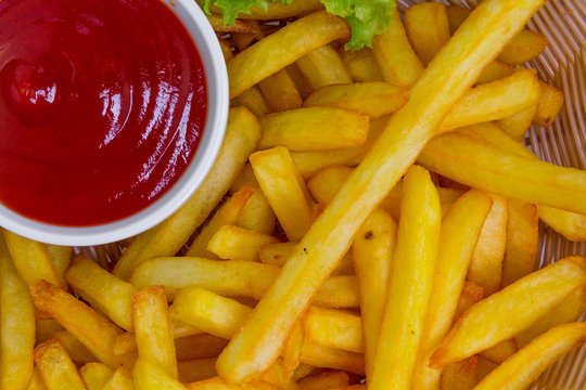 Fresh fried french fries with ketchup, closeup