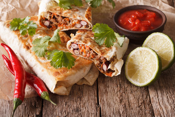 Mexican Food: chimichanga with meat and vegetables close-up 
