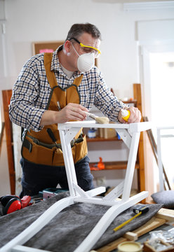 Man Painting A Chair In His Workshop.Small Business.