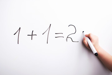 one plus one. child solves an example
