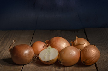 Onions lies on the old wooden table