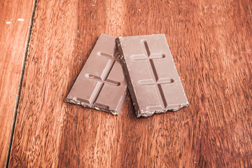 Chocolate on wood background, made vintage color tone