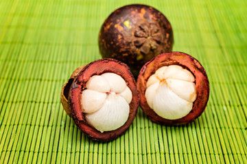 Mangosteen fruit on a green bamboo