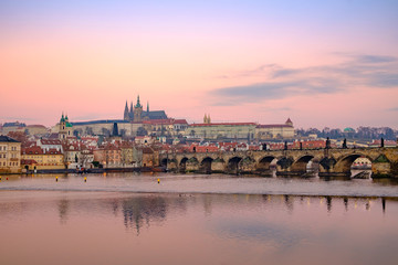 Fototapeta premium View of Prague castle and Charles bridge at colorful sunrise