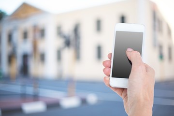Composite image of hand showing smartphone 