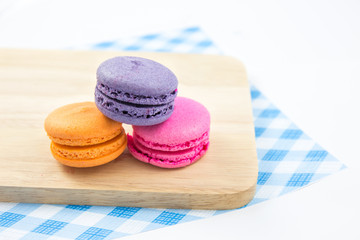 Colorful macaroons variety closeup on wood. concept resentation