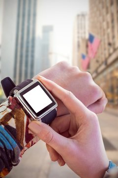 Composite image of hand touching smart watch