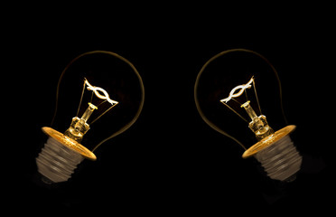 Incandescent light bulb on black background