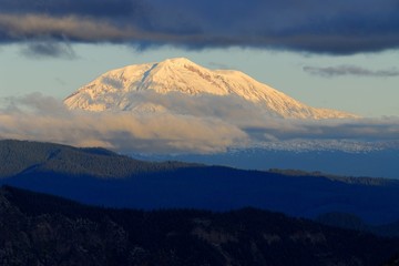 Sunset views from the Windy Ridge to Mount Adams in clouds. US Pacific Northwest, Washington.