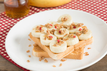 A healthy peanut butter and banana sandwich, muesli crisp with berry.