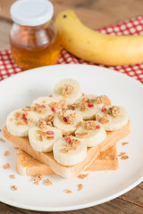 A healthy peanut butter and banana sandwich, muesli crisp with berry.