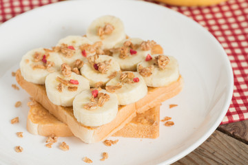 A healthy peanut butter and banana sandwich, muesli crisp with b