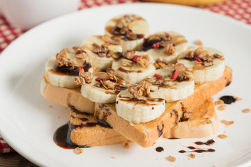 Sandwich peanut butter with banana and muesli crisp with chocola