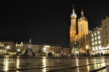 Fototapeta na wymiar View of the Main Market Square and St. Mary's Church at night located in Krakow, Poland