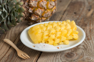 Sliced Pineapple on white plate.