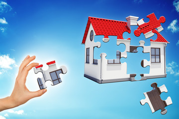 Hand making house puzzle
