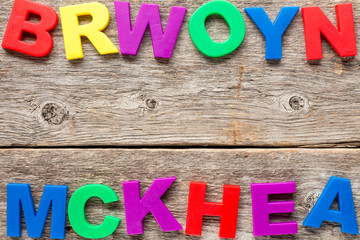 Wooden background with toy letters