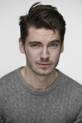 Fototapeta premium Young handsome guy portrait in front of white background