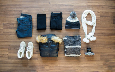 Winter clothes on wooden background. View from above