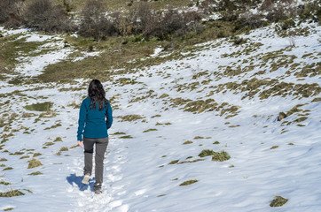 Woman trekking in winter mountains.