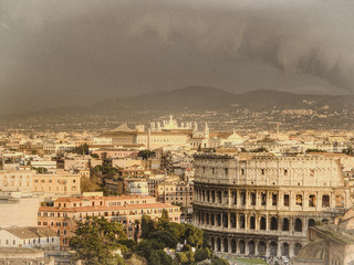 Fototapeta premium Air view of Rome on the background of clouds and mountains. Retro toned photo.