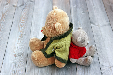 Two Teddy bear sitting backs to each other. Friendship, resentment, strife.
