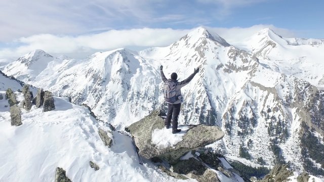 Successful Young Man Standing On Top Of Mountain Cliff Edge Worship Pose Thanks Giving Religion Christianity Joy Happiness Achievement Aerial Drone Flight