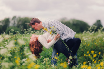 Man and woman dance on the meadow