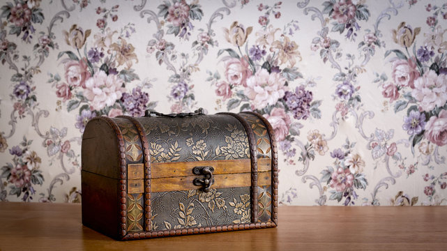 Jewelry chest on the table with vintage floral background 