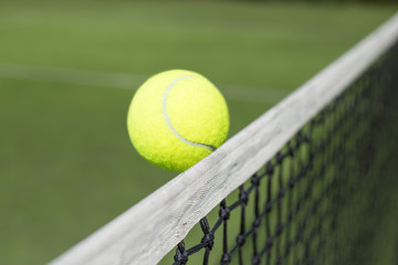 Tennis ball touching net 