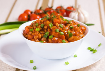 Braised beans with mushrooms, red cherry and garlic clove
