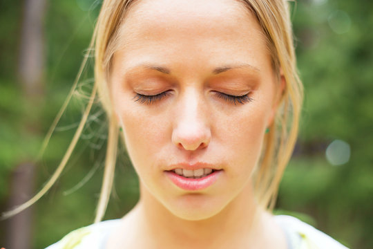 Athletic woman with closed eyes after workout 