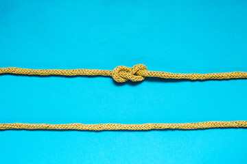 Eight knot on a blue background. Photo of a series of nautical knots. © Olha Kozachenko