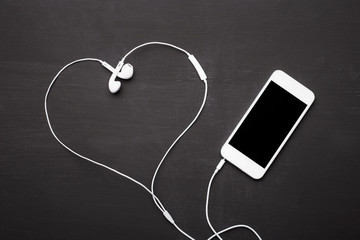 Heart shaped headphones wit smartphone 