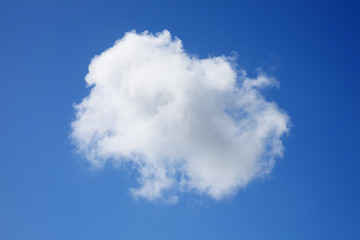 Background of a one single fluffy cumulus cloud in a blue clear sky