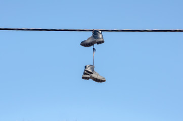 Obraz premium boots hanging from wire