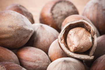 Hazelnut on wooden table background.